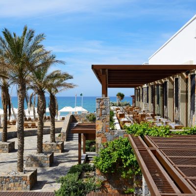 The outdoor restaurant with view on a beach at luxury hotel, Crete, Greece